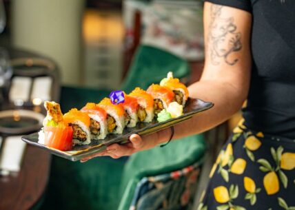 Lantern roll Lantern Roll - a delicious uramaki (california roll) filled with soft shell tempura, mango and mixed leaf, then topped with fresh salmon and tuna sashimi