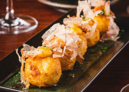Takoyaki - Osaka street food favourite Takoyaki. Osaka’s famous octopus dumplings. Crisp on the outside, soft inside. Topped with tonkatsu sauce, spicy mayo & bonito flakes