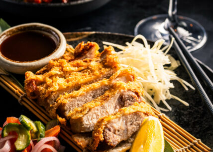 black pork katsu panko-fried, crispy kurobuta pork cutlet with shredded cabbage, pickles & tonkatsu sauce. a signature classic from kagoshima black pork katsu panko-fried, crispy kurobuta pork cutlet with shredded cabbage, pickles & tonkatsu sauce. a signature classic from kagoshima