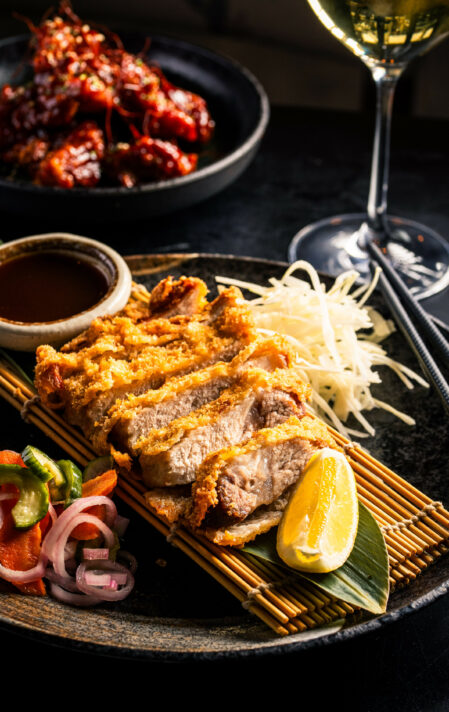 black pork katsu panko-fried, crispy kurobuta pork cutlet with shredded cabbage, pickles & tonkatsu sauce. a signature classic from kagoshima