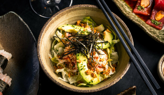 kani salad - crab salad. red snow crab, lettuce, avocado & tobiko with a sweet & sour tosazu jelly dressing, topped with chives & crispy onion